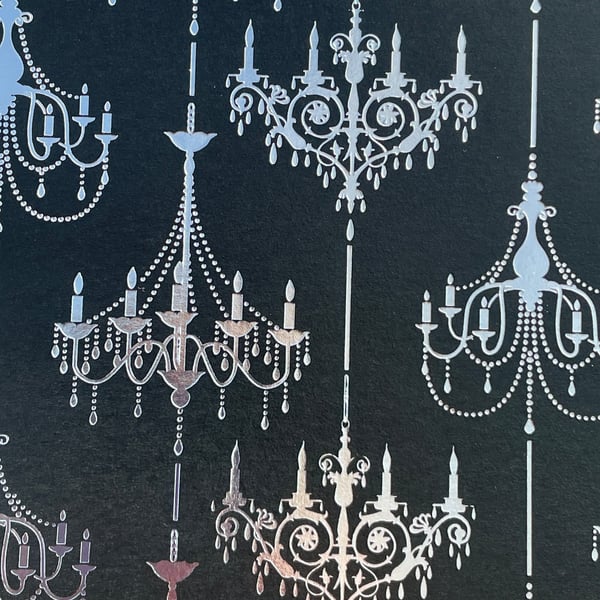 Four sheets of black card with silver and gold printed chandeliers