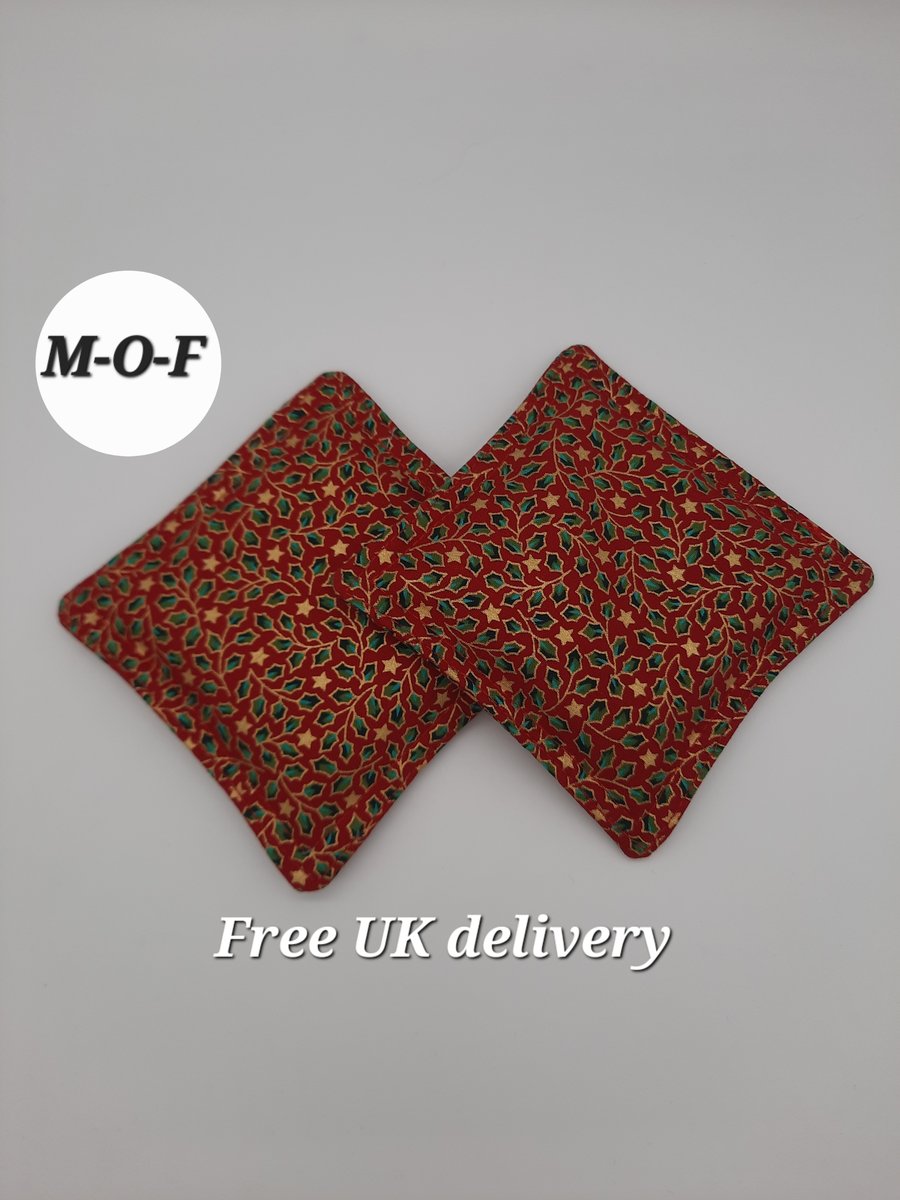 Hand warmers - green holly on a red background.  