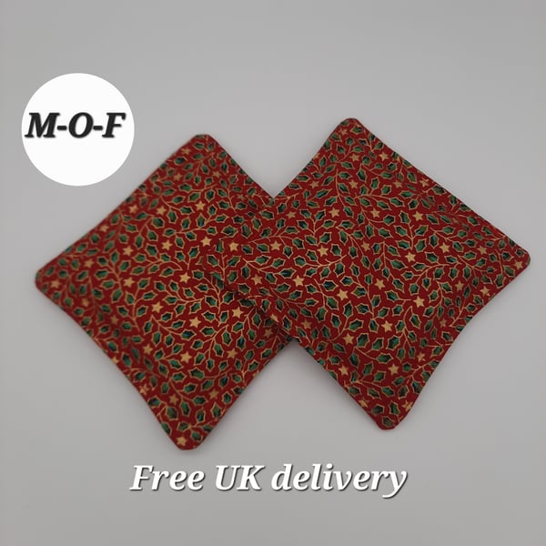 Hand warmers - green holly on a red background.  