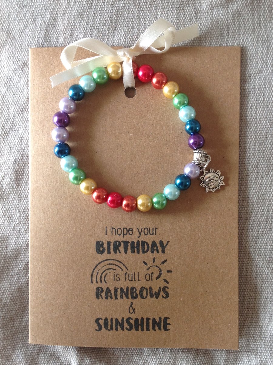 Stretch bracelet, hand strung, with charm attached, on an A6