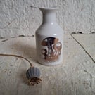 Stoneware bud vase with a copper toadstool image