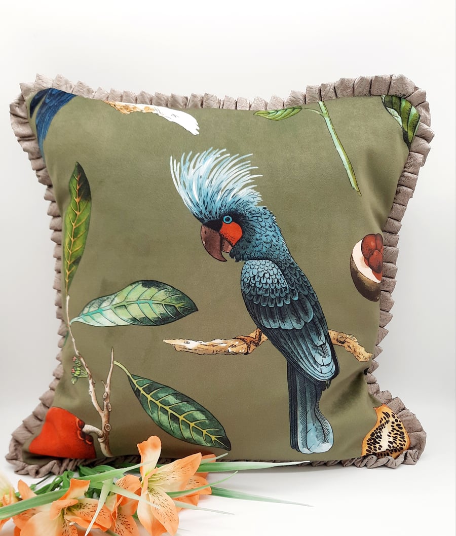 Bird velvet cushion cover in green with frilled edging. 