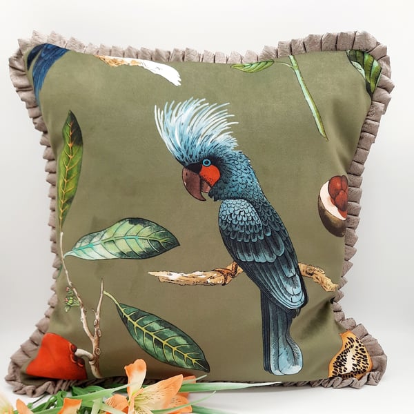 Bird velvet cushion cover in green with frilled edging. 