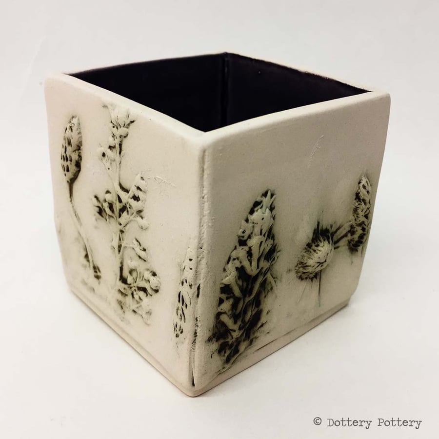 Small ceramic slab pot with natural flower design and purple interior