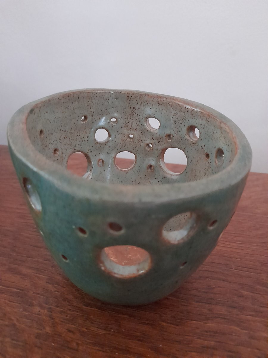Handmade ceramic pot with hole decoration 