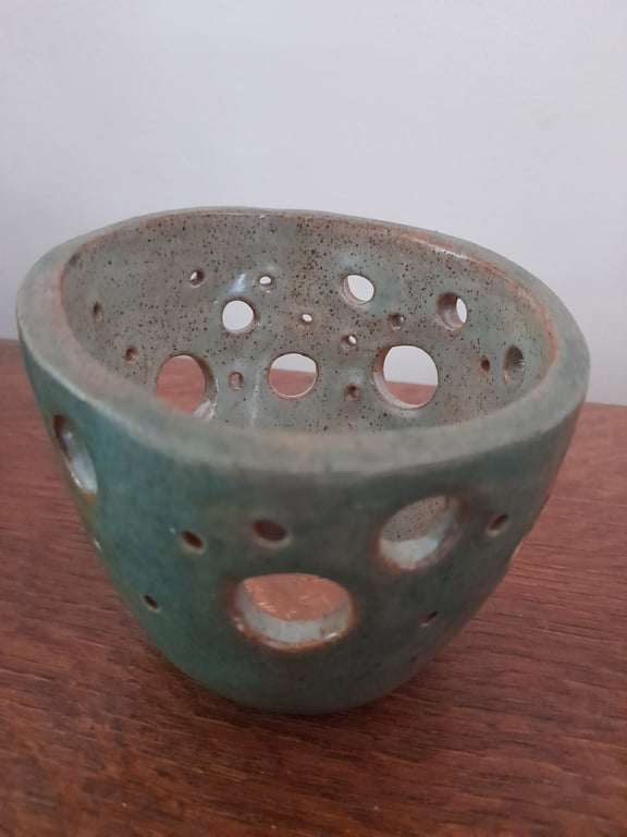 Handmade ceramic pot with hole decoration 