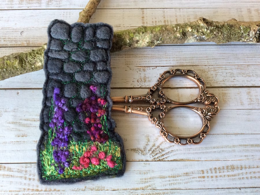 Embroidered wall and flower bookmark. 