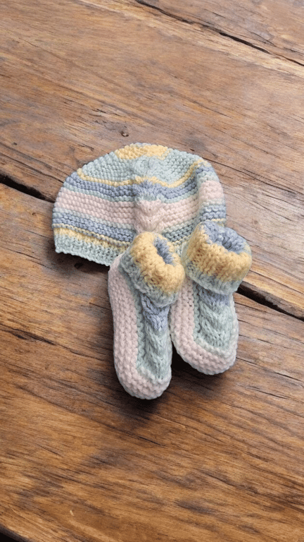 Handknitted multicoloured baby hat and matching booties