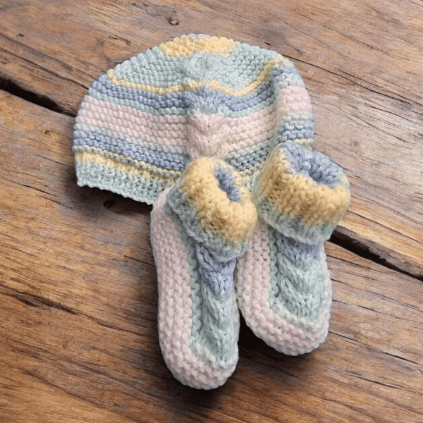 Handknitted multicoloured baby hat and matching booties