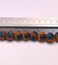 Handmade teal and mustard daisy patterned lamp work glass beads - Image 9