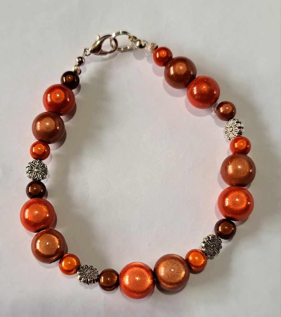 Disco beaded wired bracelet, brown, orange and black