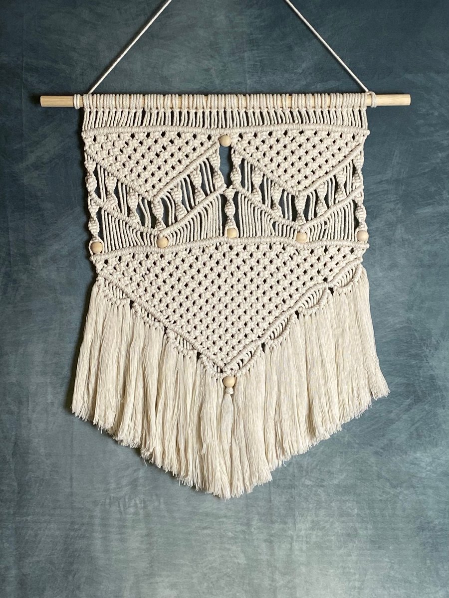 Handmade macrame wall hanging decoration with wooden beads and fringe