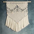 Handmade macrame wall hanging decoration with wooden beads and fringe