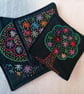 Set of four embroidered fabric coasters.  - Image 1
