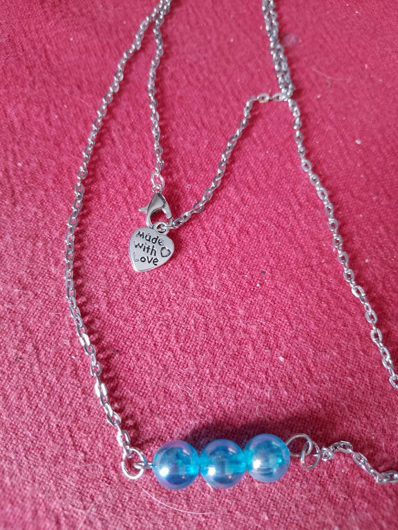 Handmade silver plated necklace with blue beads.