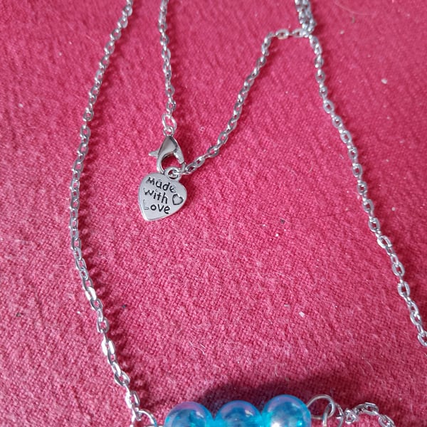 Handmade silver plated necklace with blue beads.