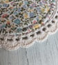 Set of four floral coasters with crochet edge. - Image 4