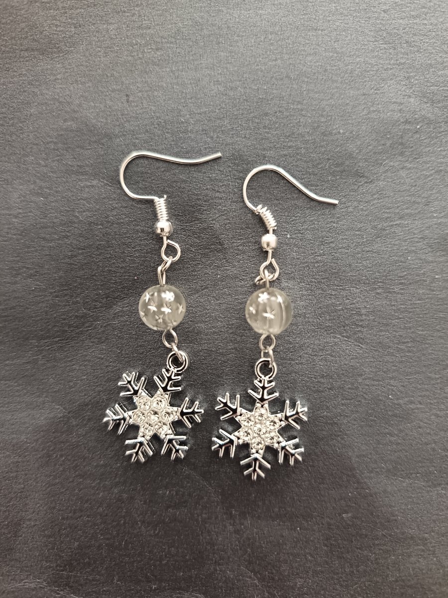 Silver snowflake charm earrings with star bead detail