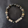 Elasticated endometriosis bracelet with charcoal glass beads and star detail