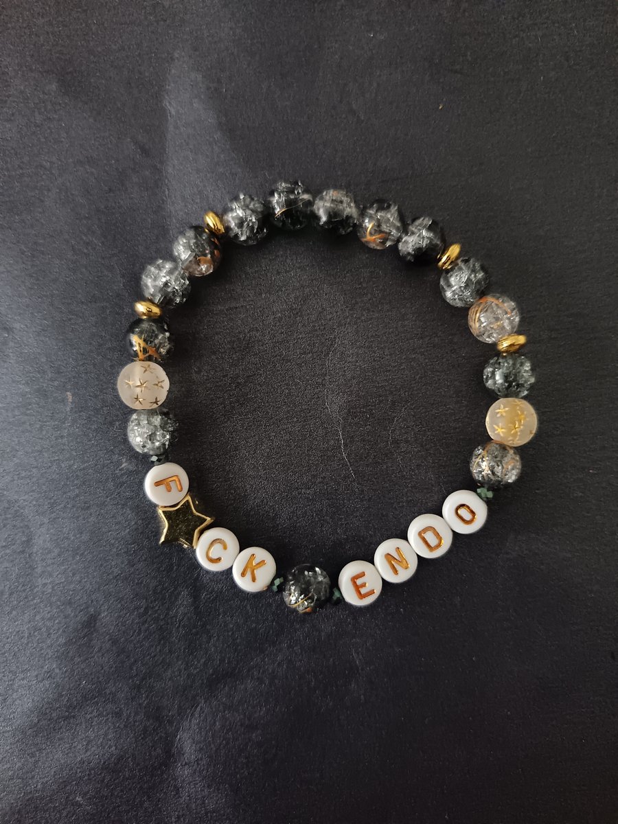 Elasticated endometriosis bracelet with charcoal glass beads and star detail