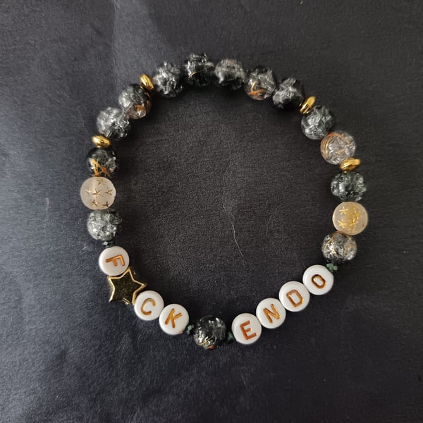 Elasticated endometriosis bracelet with charcoal glass beads and star detail