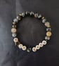 Elasticated endometriosis bracelet with charcoal glass beads and star detail