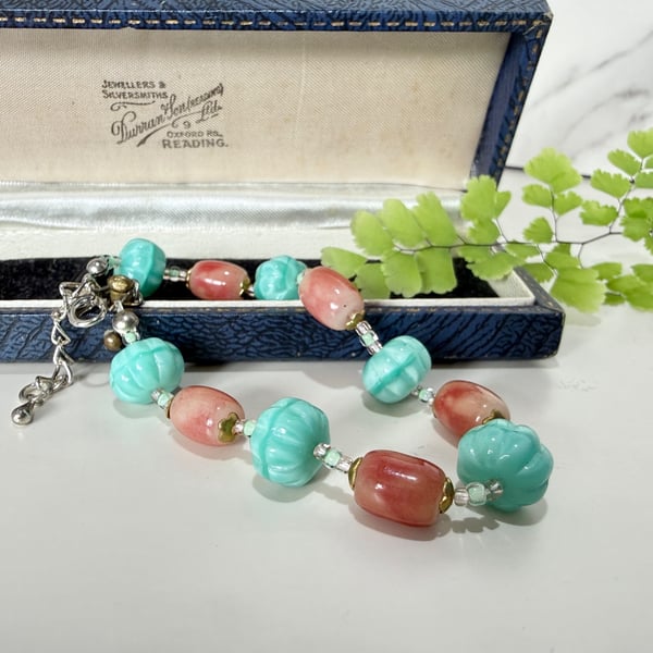Teal and pink glass bead bracelet with extender chain. 