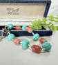 Teal and pink glass bead bracelet with extender chain. 
