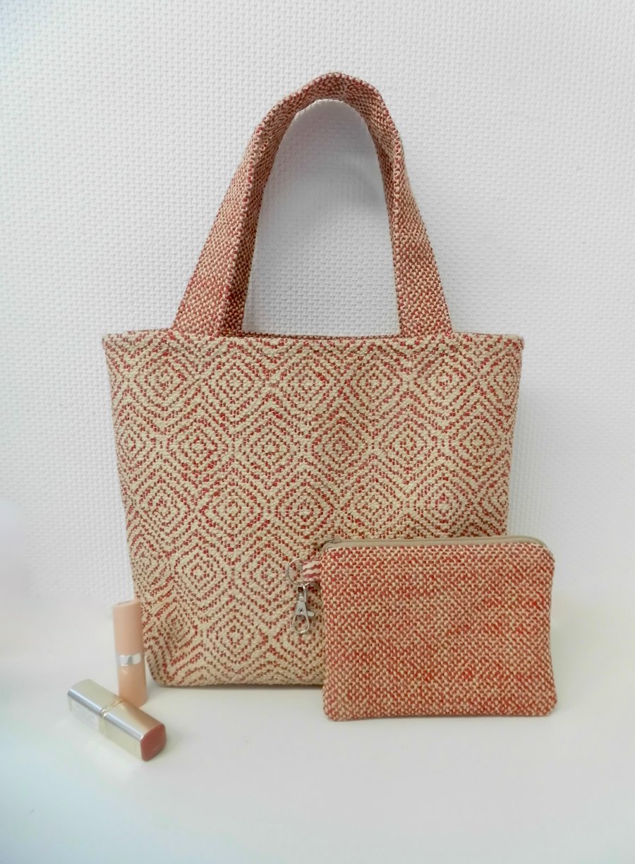Bucket hand bag and matching purse set in muted red textured fabric.