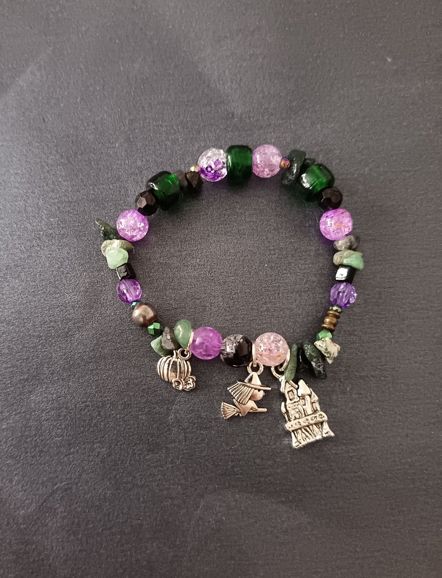 Elasticated spooky silver charm bracelet with purple, green and black beads