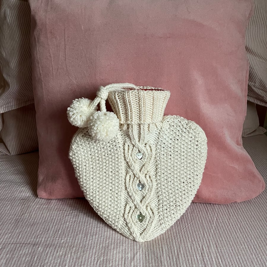 Heart shaped hot water bottle with hand knit cover