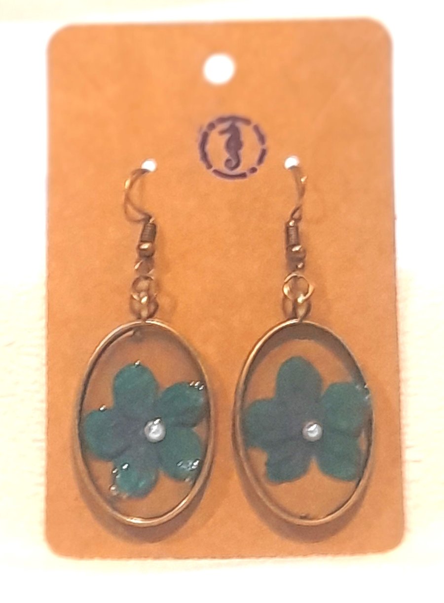 Resin earrings with blue flower inclusion