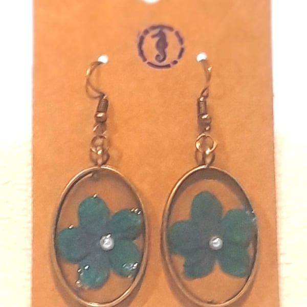 Resin earrings with blue flower inclusion