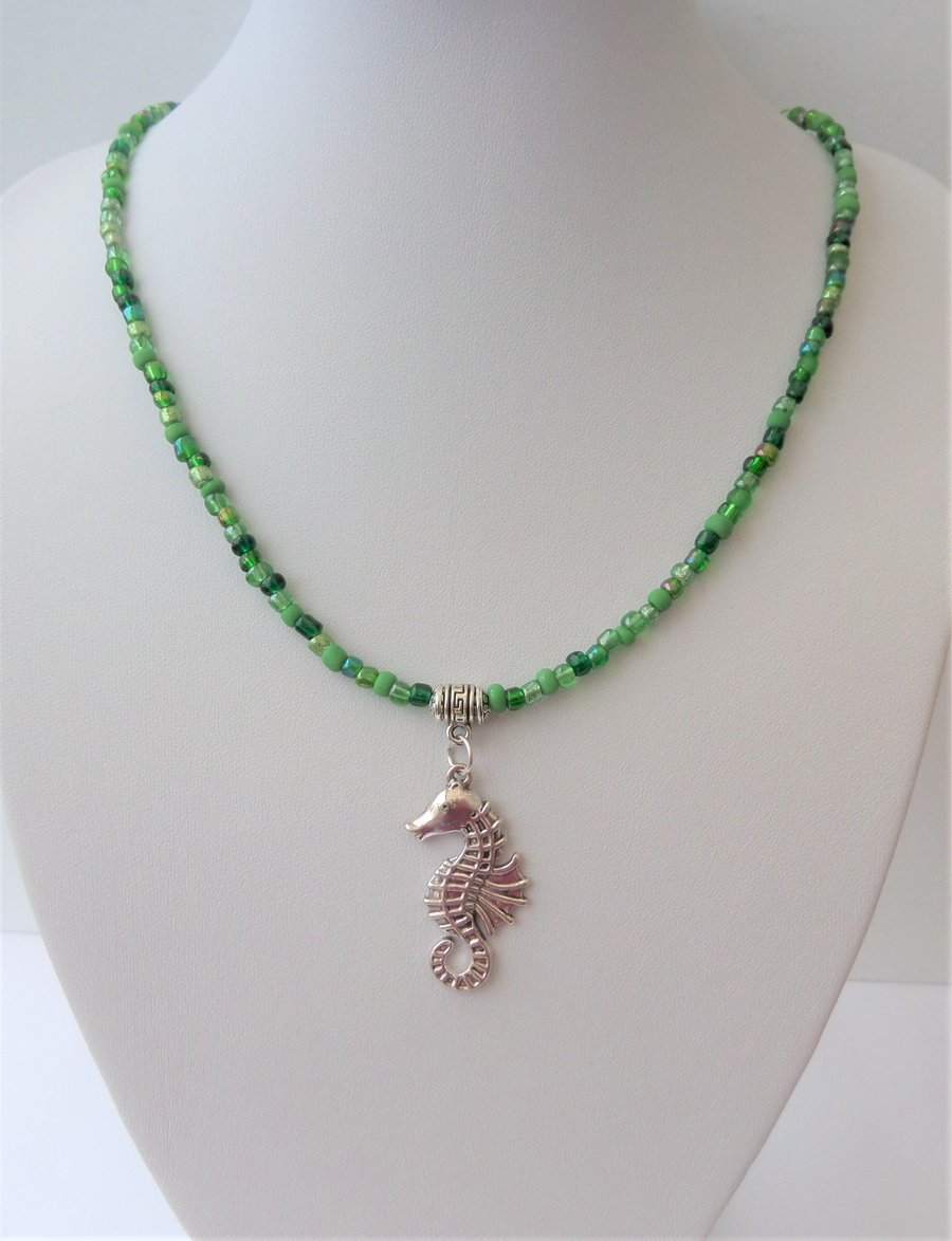 Green seed bead mix necklace with sea horse pendant.