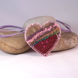 Love heart machine and hand embroidered textile necklace in pinks 