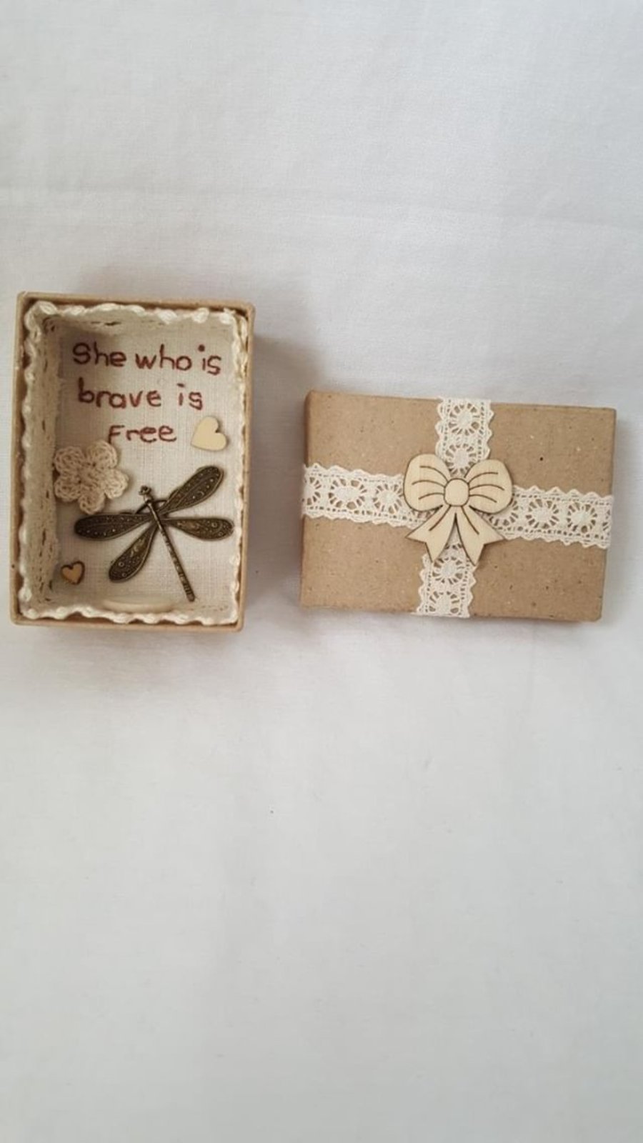 small miniature art diorama with a message 'she who is brave is free'