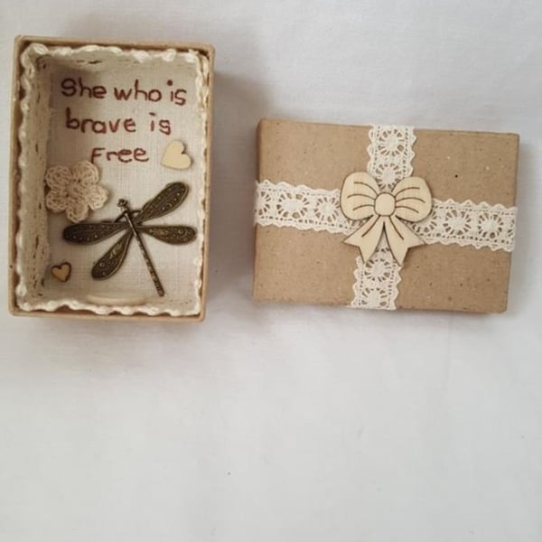 small miniature art diorama with a message 'she who is brave is free'