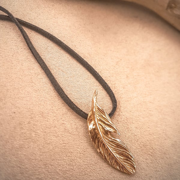 Solid bronze feather pendant on faux suede lace necklace