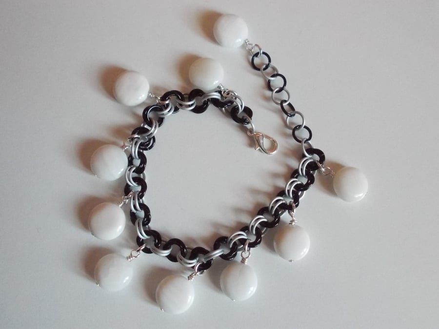 Monochrome chainmaille bracelet with shell coin charms