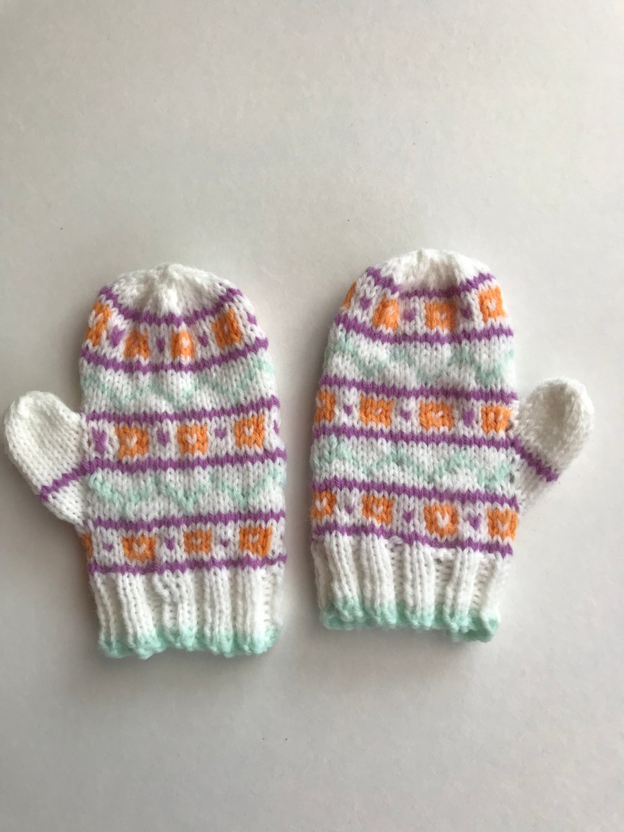Fair isle pattened baby mittens with thumbs.