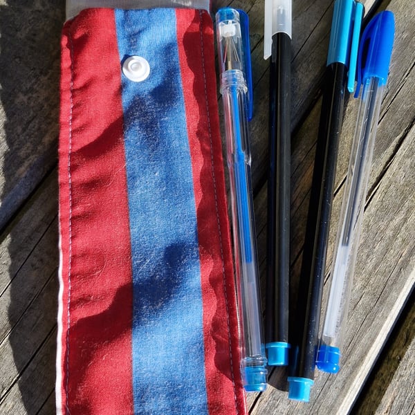 Blue and red striped pen case with 4 blue pens 