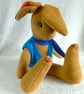 Lupin, a 16" fleece unjointed rabbit with neckerchief and knitted waistcoat. - Image 1