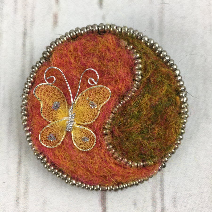 Butterfly brooch, needle felted in orange with silver beading