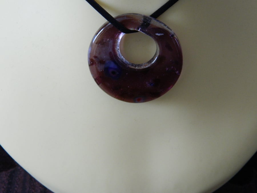 Pendant on black suede cord.  
