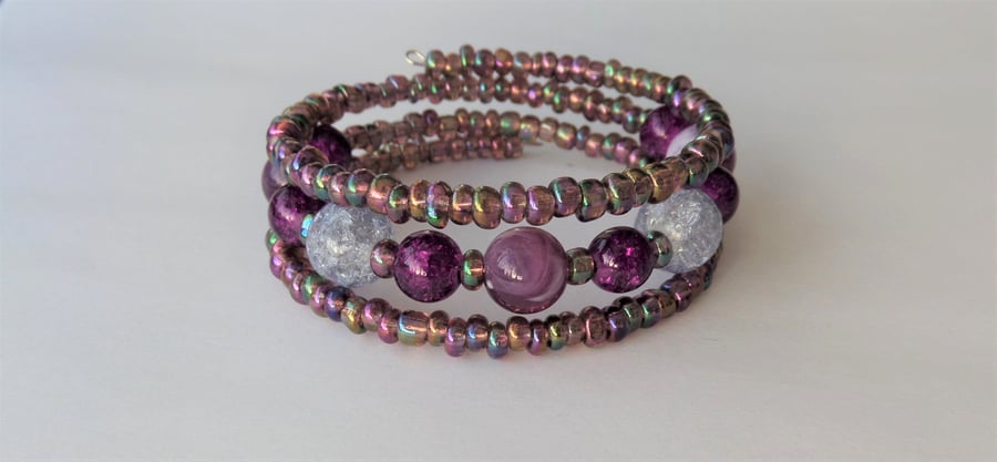 Clear and purple and metallic seed bead memory wire wrap bracelet.