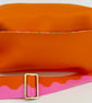 Bright orange faux leather crossbody bag with jazzy lining and roomy interitor
