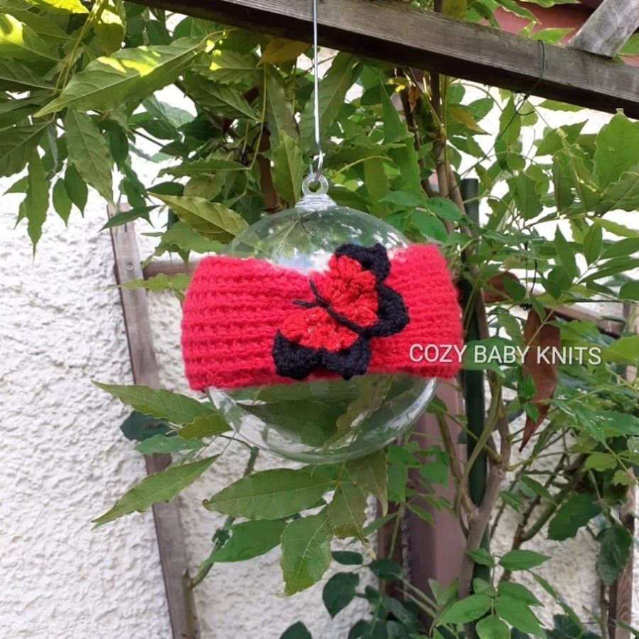 ARAN  EARWARMER WITH A BUTTERFLY APPLIQUED ON IT