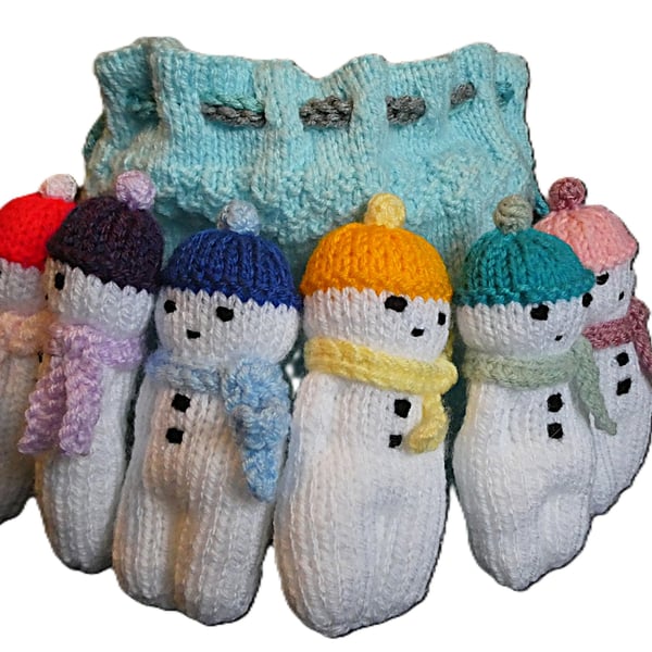 Handmade knitted snowmen in drawstring bag