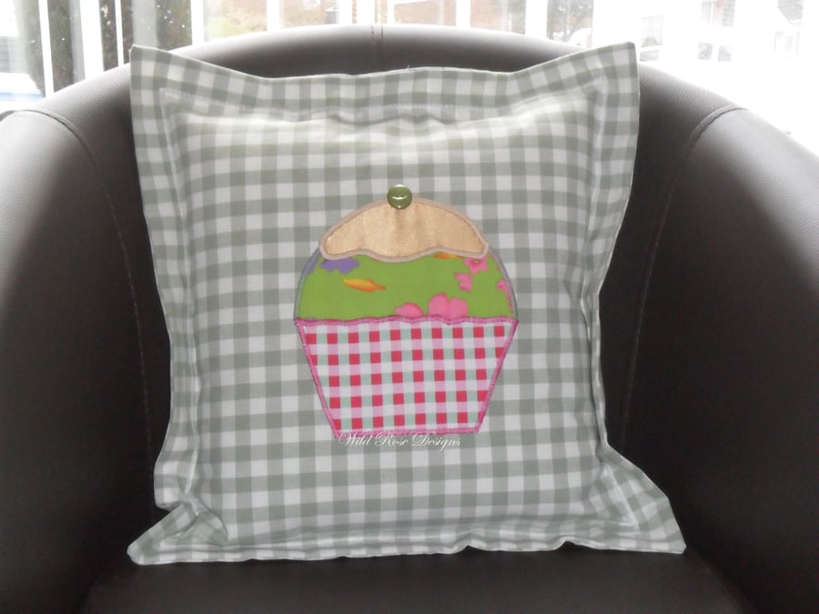 Cushions with appliqued cupcake. 