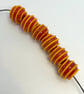 Handmade dark orange and yellow striped lamp work glass beads - Image 2